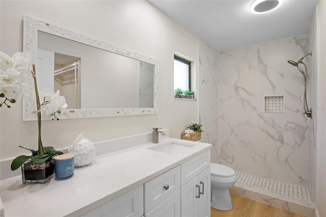 3518 Wilkinson Woods Dr Unit 11, Sarasota, FL 34231 - full bath with a marble finish shower, vanity, and wood finished floors