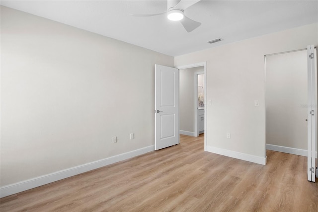 3518 Wilkinson Woods Dr Unit 11, Sarasota, FL 34231 - unfurnished bedroom with light wood-style floors and a ceiling fan