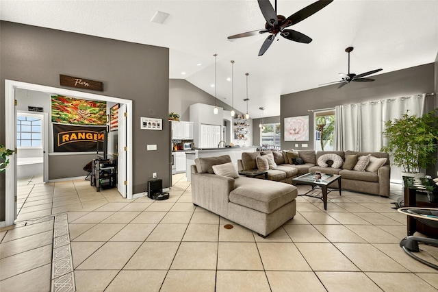 4668 73rd St E, Bradenton, FL 34203 - living area with high vaulted ceiling, ceiling fan, light tile patterned floors, and plenty of natural light