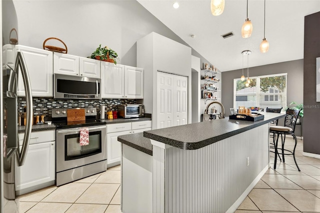 4668 73rd St E, Bradenton, FL 34203 - kitchen with stainless steel appliances, dark countertops, light tile patterned floors, tasteful backsplash, and high vaulted ceiling