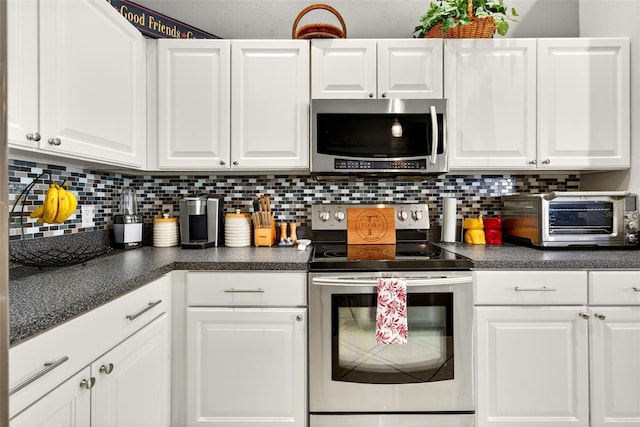 4668 73rd St E, Bradenton, FL 34203 - kitchen with appliances with stainless steel finishes, white cabinetry, dark countertops, and backsplash