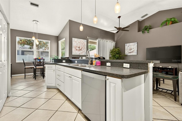 4668 73rd St E, Bradenton, FL 34203 - kitchen with stainless steel dishwasher, vaulted ceiling, a ceiling fan, open floor plan, and light tile patterned floors