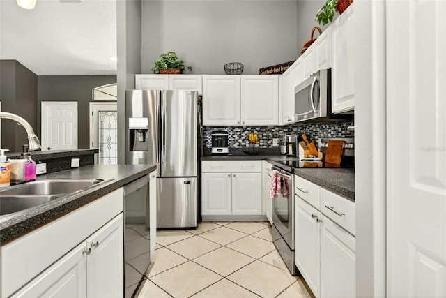 4668 73rd St E, Bradenton, FL 34203 - kitchen featuring stainless steel appliances, dark countertops, white cabinets, and backsplash