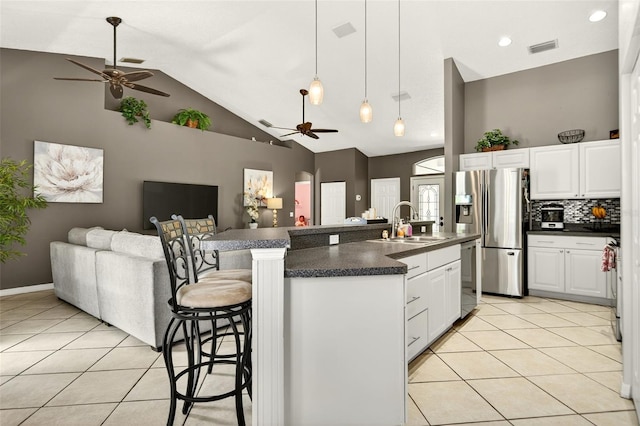 4668 73rd St E, Bradenton, FL 34203 - kitchen featuring a ceiling fan, open floor plan, stainless steel appliances, dark countertops, and light tile patterned flooring