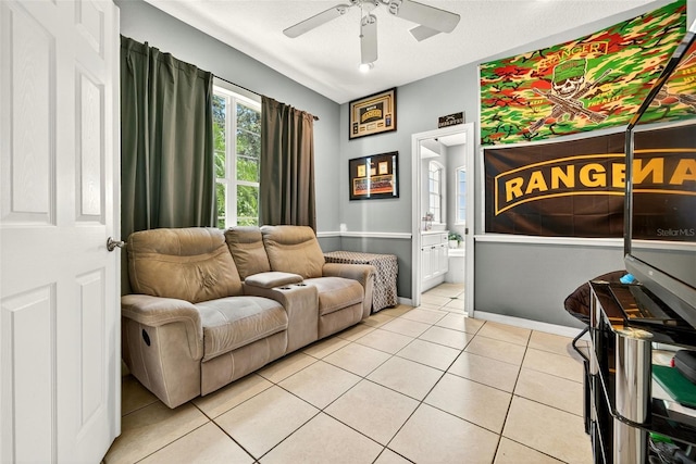 4668 73rd St E, Bradenton, FL 34203 - living room with light tile patterned floors and a ceiling fan