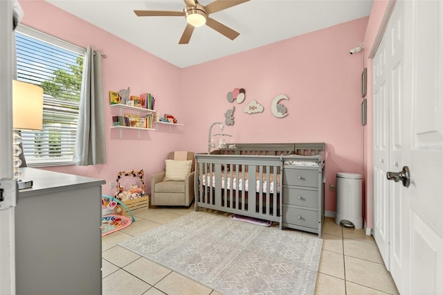 4668 73rd St E, Bradenton, FL 34203 - tiled bedroom featuring a nursery area, a closet, multiple windows, and a ceiling fan