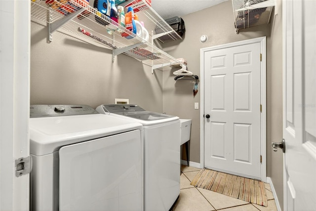 4668 73rd St E, Bradenton, FL 34203 - washroom featuring washer and dryer and light tile patterned flooring