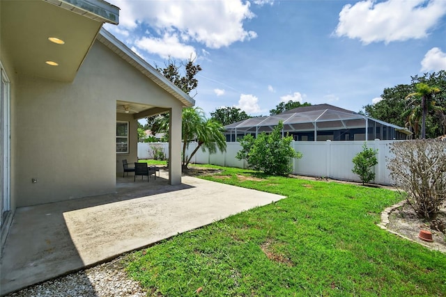 4668 73rd St E, Bradenton, FL 34203 - fenced backyard with a patio and ceiling fan