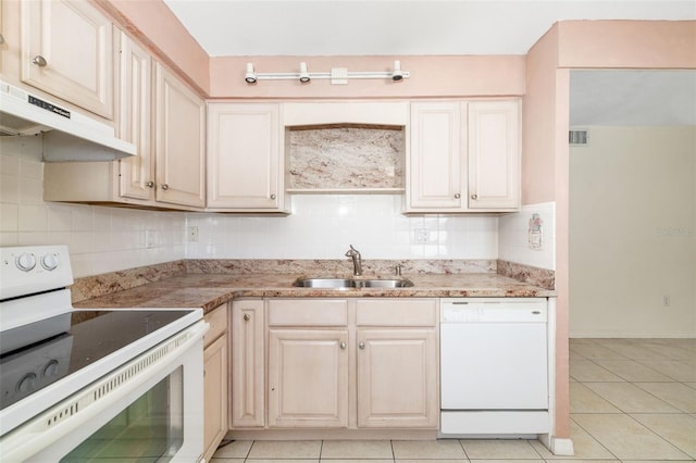 510 Granada Ave Unit 108, Venice, FL 34285 - kitchen with white appliances, under cabinet range hood, light tile patterned flooring, and tasteful backsplash