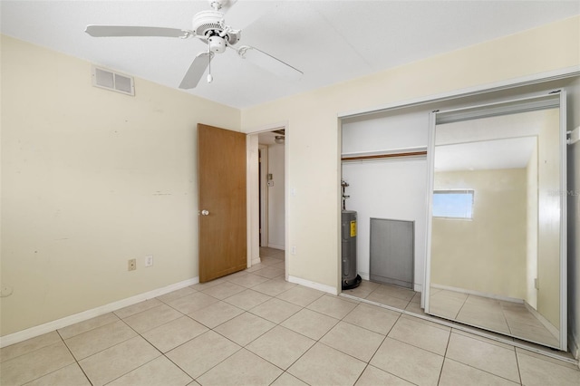 510 Granada Ave Unit 108, Venice, FL 34285 - unfurnished bedroom with light tile patterned floors, a closet, ceiling fan, and water heater
