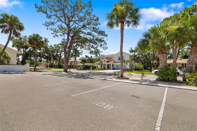 510 Granada Ave Unit 108, Venice, FL 34285 - uncovered parking lot featuring a residential view