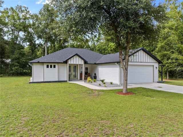 174 SW Caboose Dr, Fort White, FL 32038 - view of front of property featuring a garage, driveway, board and batten siding, a front yard, and roof with shingles