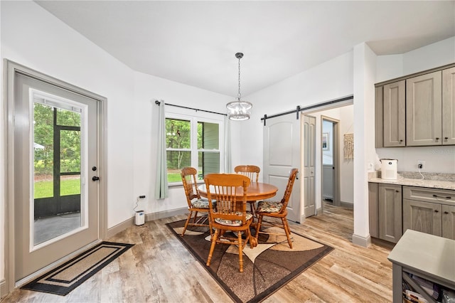 174 SW Caboose Dr, Fort White, FL 32038 - dining space featuring a barn door and light wood finished floors