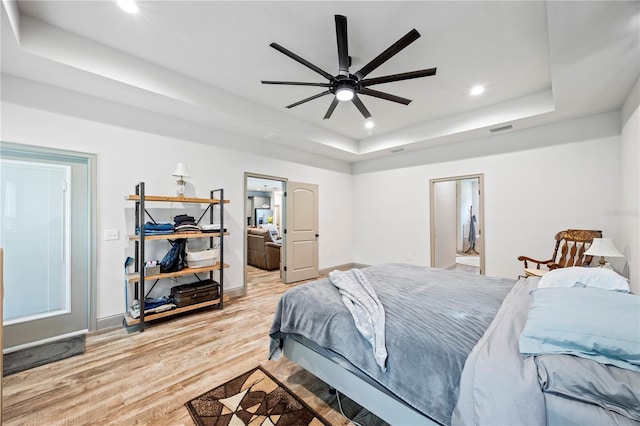 174 SW Caboose Dr, Fort White, FL 32038 - bedroom featuring a tray ceiling, recessed lighting, and light wood-style floors