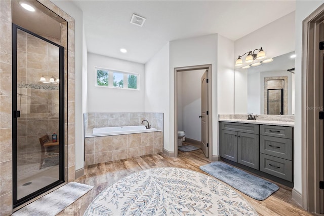 174 SW Caboose Dr, Fort White, FL 32038 - full bath featuring a bath, a shower stall, vanity, and wood finished floors