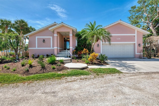 1236 Port Ln, Sarasota, FL 34242 - view of front of property with stucco siding, concrete driveway, and a garage