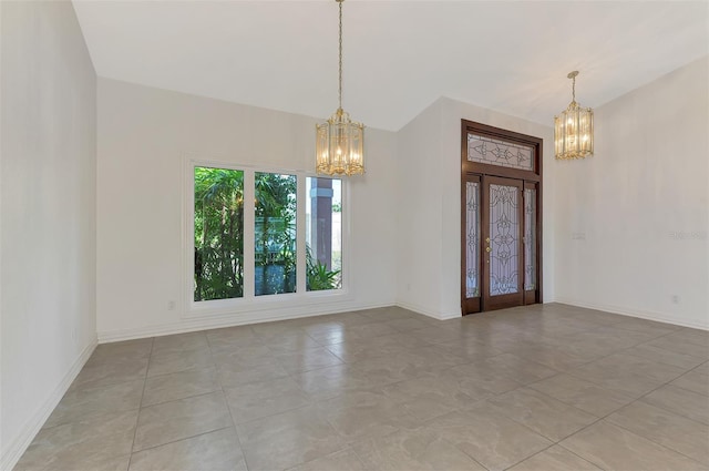 1236 Port Ln, Sarasota, FL 34242 - spare room featuring a chandelier and light tile patterned floors
