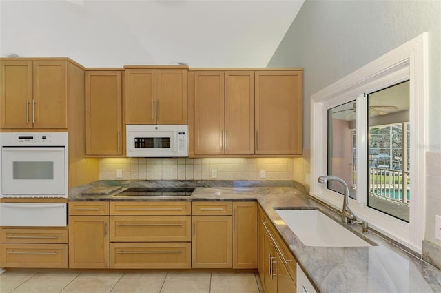 1236 Port Ln, Sarasota, FL 34242 - kitchen featuring white appliances, a warming drawer, decorative backsplash, lofted ceiling, and light tile patterned floors