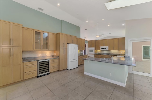 1236 Port Ln, Sarasota, FL 34242 - kitchen with white appliances, beverage cooler, light tile patterned floors, tasteful backsplash, and glass insert cabinets