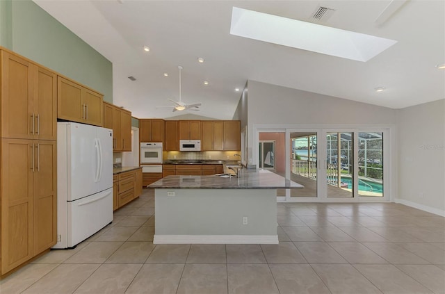1236 Port Ln, Sarasota, FL 34242 - kitchen with white appliances, high vaulted ceiling, a skylight, light tile patterned flooring, and a warming drawer