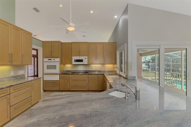 1236 Port Ln, Sarasota, FL 34242 - kitchen featuring white appliances, ceiling fan, backsplash, a warming drawer, and high vaulted ceiling