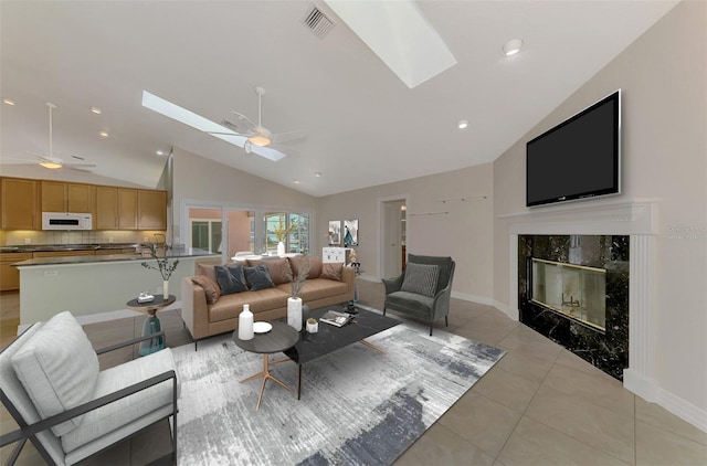 1236 Port Ln, Sarasota, FL 34242 - living room with a skylight, ceiling fan, a fireplace, light tile patterned floors, and recessed lighting
