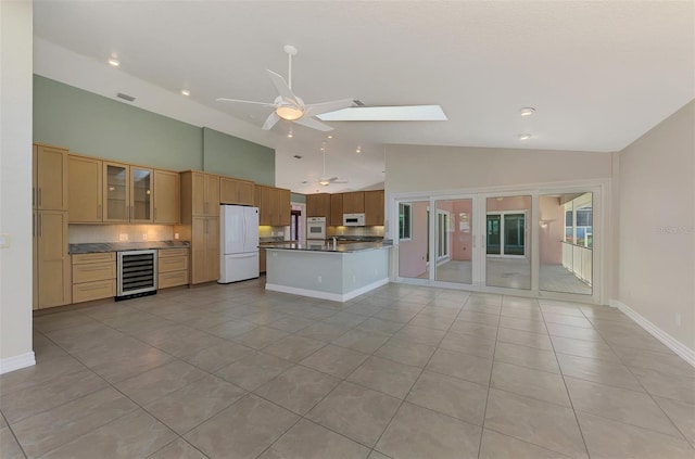 1236 Port Ln, Sarasota, FL 34242 - unfurnished living room with wine cooler, light tile patterned flooring, a ceiling fan, high vaulted ceiling, and recessed lighting