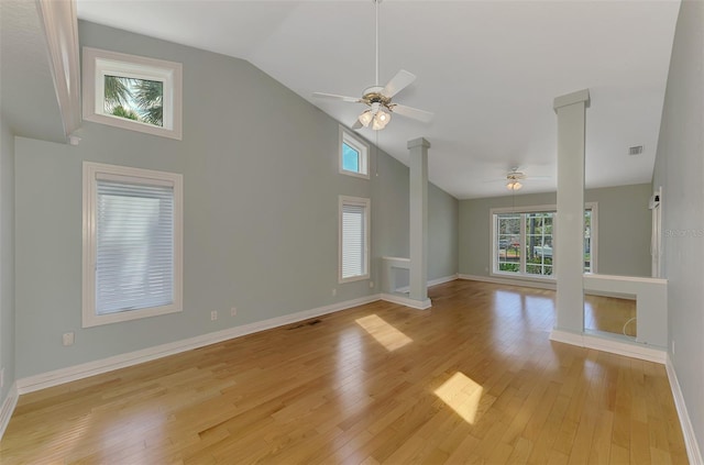 1236 Port Ln, Sarasota, FL 34242 - unfurnished living room featuring ceiling fan, ornate columns, light wood finished floors, and high vaulted ceiling