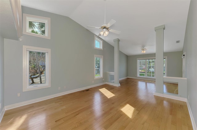 1236 Port Ln, Sarasota, FL 34242 - unfurnished living room with a ceiling fan, decorative columns, high vaulted ceiling, and light wood-style floors