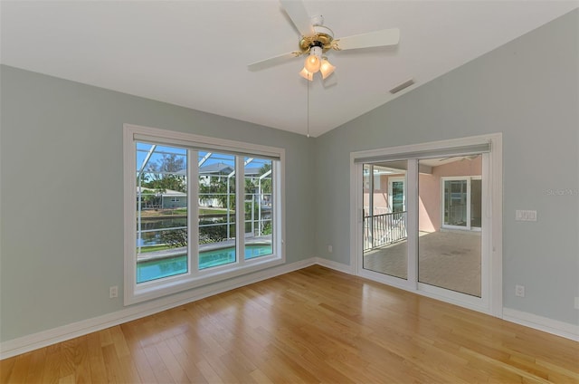 1236 Port Ln, Sarasota, FL 34242 - spare room with light wood-style flooring, vaulted ceiling, ceiling fan, and a water view