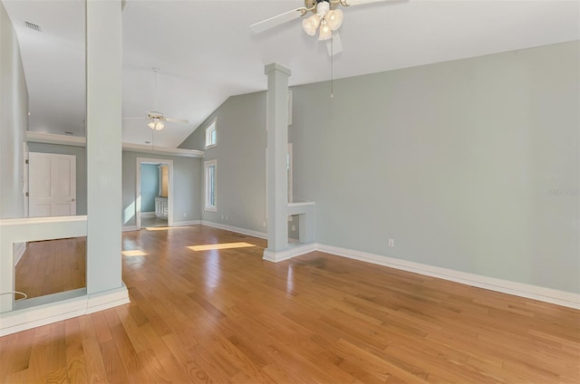 1236 Port Ln, Sarasota, FL 34242 - empty room with ceiling fan, decorative columns, wood finished floors, and high vaulted ceiling