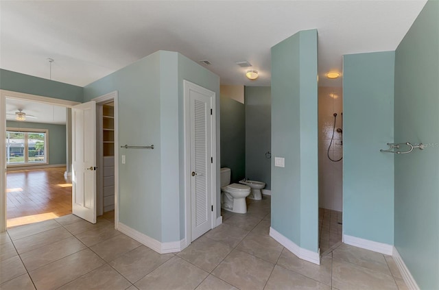 1236 Port Ln, Sarasota, FL 34242 - bathroom with a closet, a bidet, tile patterned floors, a ceiling fan, and a tile shower