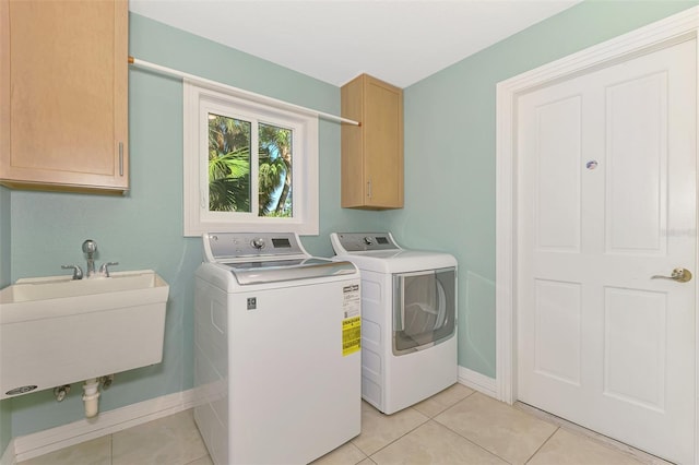 1236 Port Ln, Sarasota, FL 34242 - washroom with washing machine and dryer, cabinet space, and light tile patterned floors