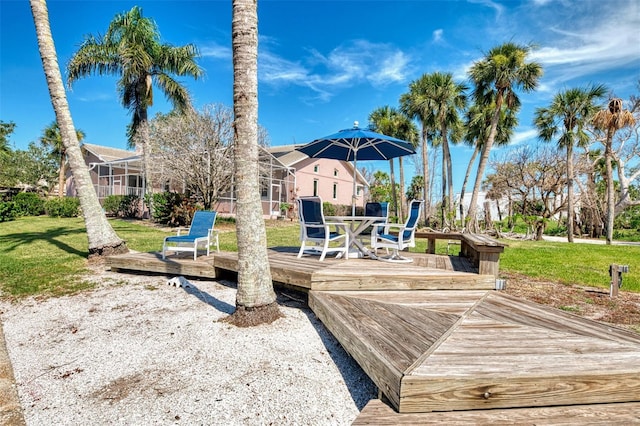 1236 Port Ln, Sarasota, FL 34242 - wooden terrace with a lawn and outdoor dining area