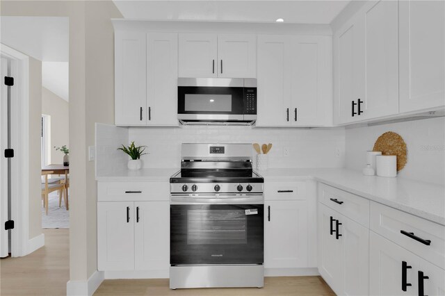 1820 Putney Cir, Orlando, FL 32837 - kitchen with stainless steel appliances, light countertops, tasteful backsplash, and white cabinets