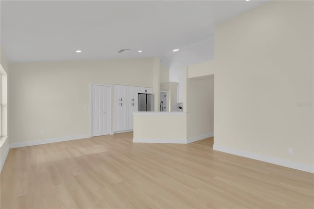 1820 Putney Cir, Orlando, FL 32837 - unfurnished living room with light wood-style flooring, recessed lighting, and high vaulted ceiling