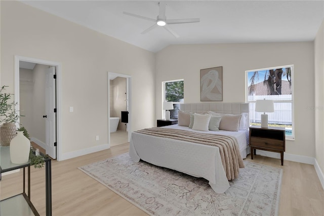 1820 Putney Cir, Orlando, FL 32837 - bedroom with light wood-type flooring, a spacious closet, lofted ceiling, connected bathroom, and a ceiling fan
