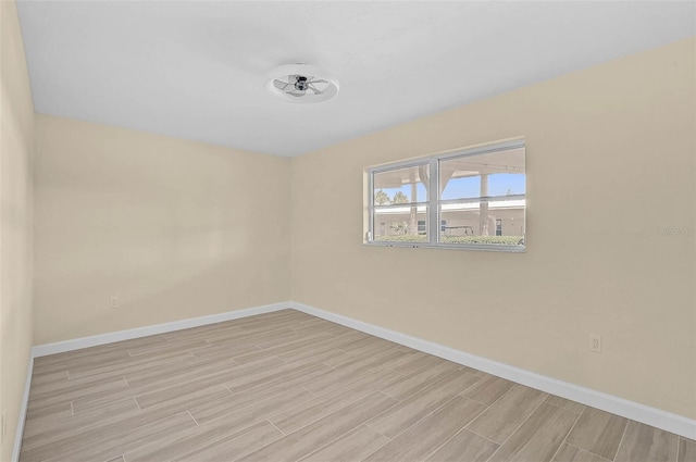 5830 Midnight Pass Rd Unit 108, Sarasota, FL 34242 - empty room featuring wood tiled floors and baseboards