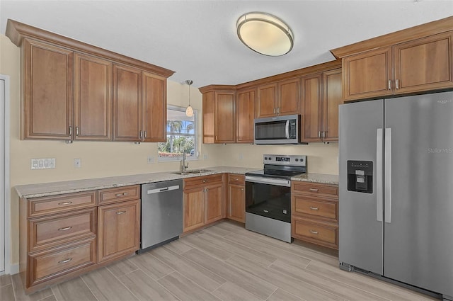 5830 Midnight Pass Rd Unit 108, Sarasota, FL 34242 - kitchen with appliances with stainless steel finishes, brown cabinetry, and pendant lighting