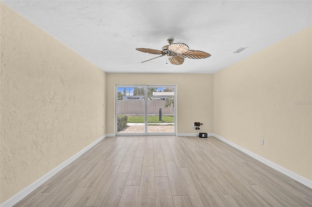 5830 Midnight Pass Rd Unit 108, Sarasota, FL 34242 - unfurnished room featuring ceiling fan, wood finished floors, and a textured wall