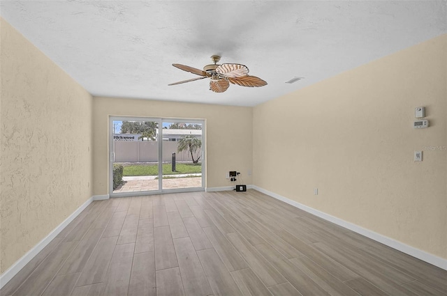 5830 Midnight Pass Rd Unit 108, Sarasota, FL 34242 - unfurnished room featuring wood finished floors, a textured wall, and a ceiling fan