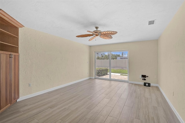 5830 Midnight Pass Rd Unit 108, Sarasota, FL 34242 - empty room with light wood-style floors, a textured wall, ceiling fan, and a textured ceiling