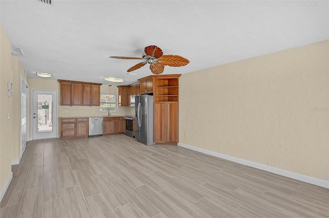 5830 Midnight Pass Rd Unit 108, Sarasota, FL 34242 - kitchen with stainless steel appliances, open shelves, ceiling fan, light countertops, and light wood-style floors