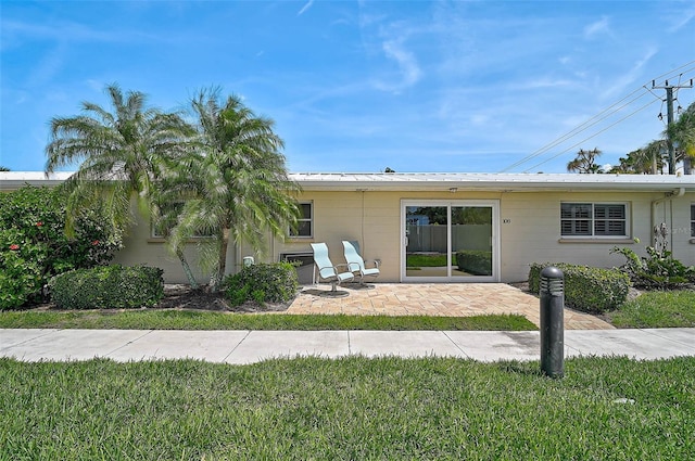 5830 Midnight Pass Rd Unit 108, Sarasota, FL 34242 - back of house with a patio area and a yard