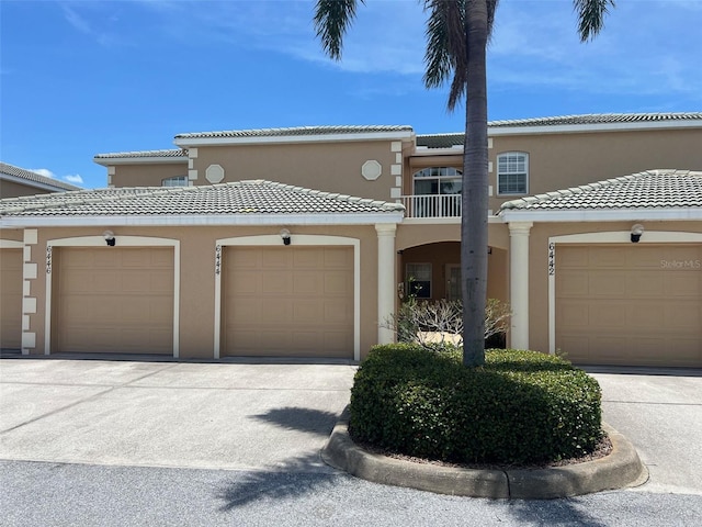 6444 7th Avenue Cir W Unit 6444, Bradenton, FL 34209 - view of front of home with a tiled roof, stucco siding, and a balcony