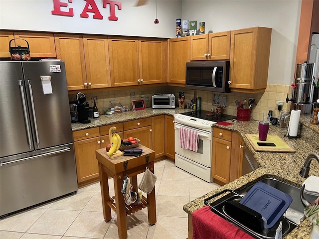 6444 7th Avenue Cir W Unit 6444, Bradenton, FL 34209 - kitchen featuring appliances with stainless steel finishes, brown cabinets, and backsplash