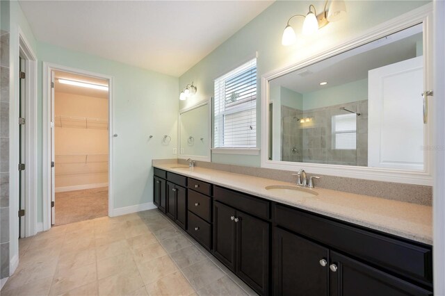 11680 Tapestry Ln, Venice, FL 34292 - full bathroom featuring double vanity, a stall shower, a walk in closet, and tile patterned flooring