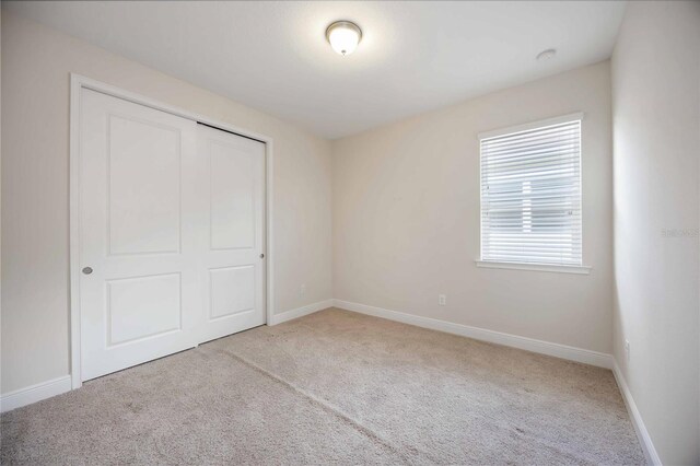 11680 Tapestry Ln, Venice, FL 34292 - unfurnished bedroom featuring carpet and a closet