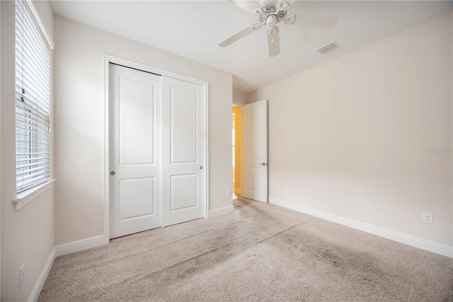 11680 Tapestry Ln, Venice, FL 34292 - unfurnished bedroom with carpet, multiple windows, a closet, and ceiling fan