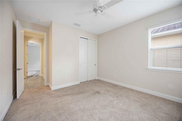 11680 Tapestry Ln, Venice, FL 34292 - unfurnished bedroom featuring carpet flooring, a closet, and ceiling fan